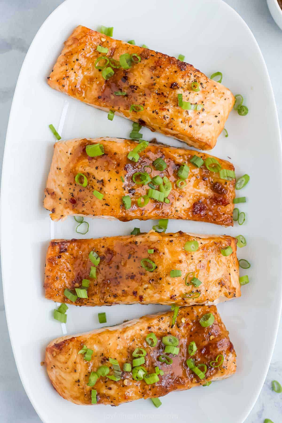 This healthy sweet chili salmon recipe is high in protein, low in calories, and only takes 30 minutes to make. The air fryer makes it easy! Overhead view of sweet chili salmon on platter