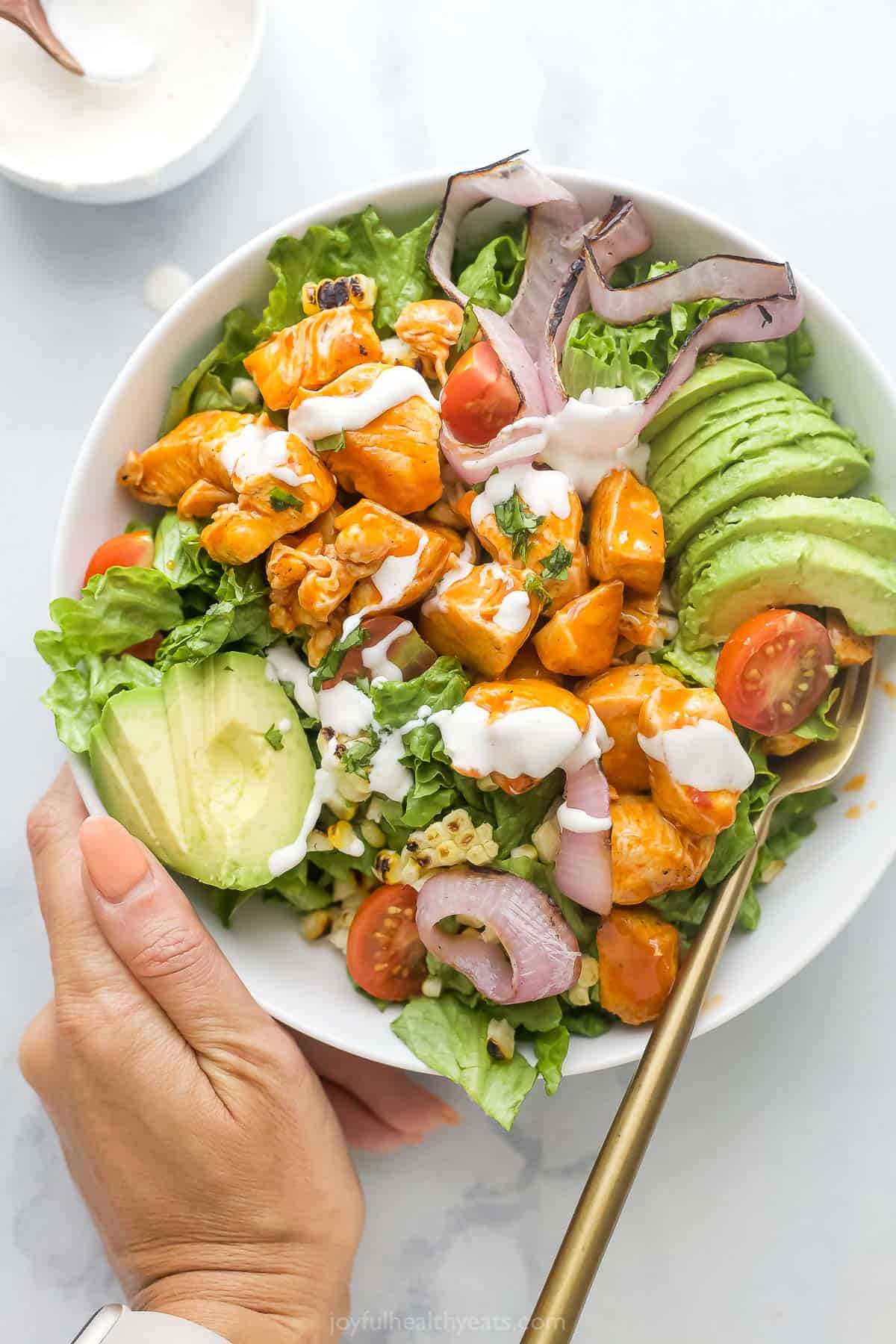 Bowl of chicken salad with grilled veggies and Ranch dressing. 