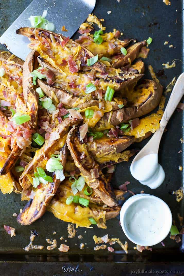 Loaded Sweet Potato Wedges topped with bacon, cheese and scallions