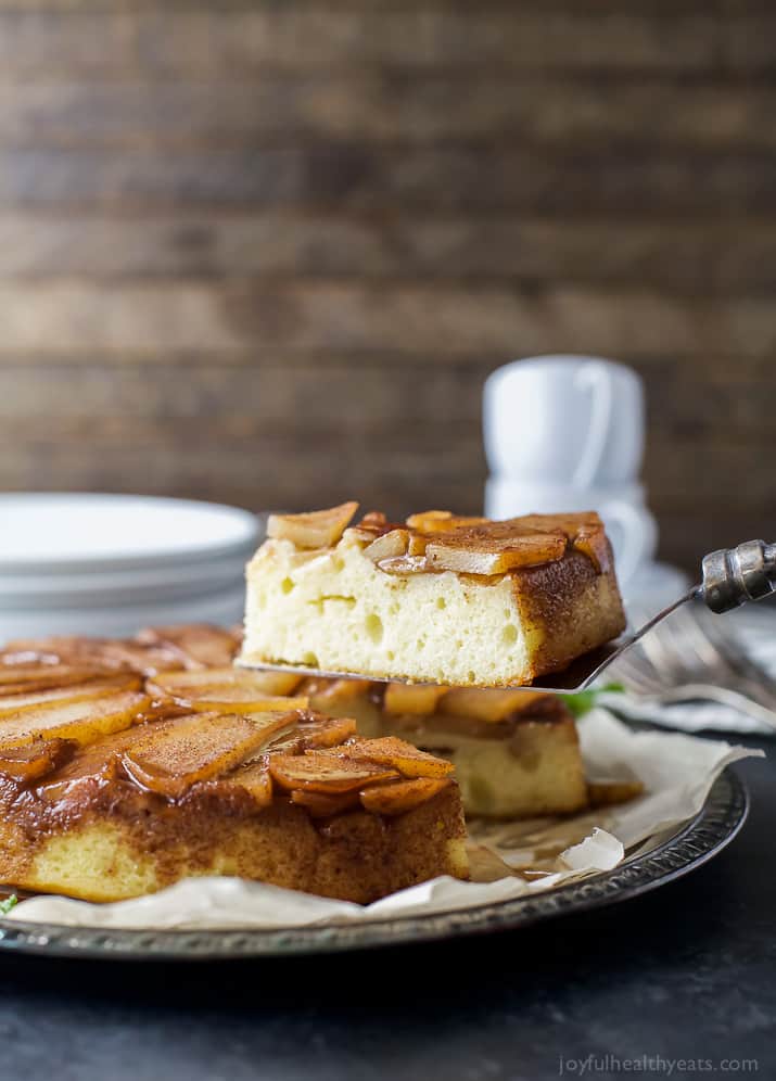 Grabbing a slice of pear cake with caramelized pears on top.