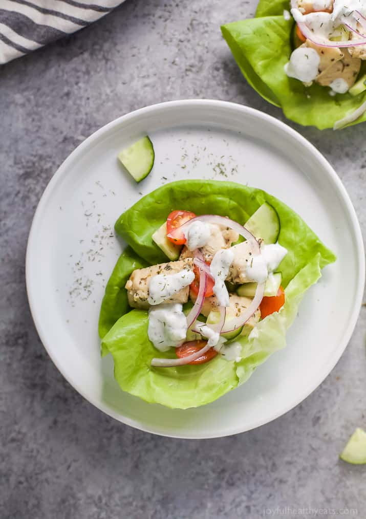 Top view of a Greek Chicken Lettuce Wraps with Tzatziki Sauce on a plate