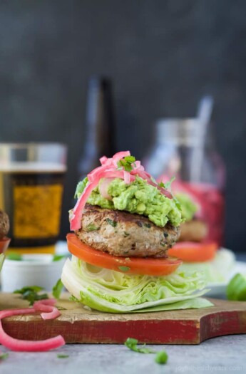 Healthy Paleo Chipotle Turkey Burgers filled with tex-mex flavor then topped with zesty guacamole and pickled onions. These Turkey Burgers are low carb, high in protein, done in 30 minutes and guaranteed to be a favorite!