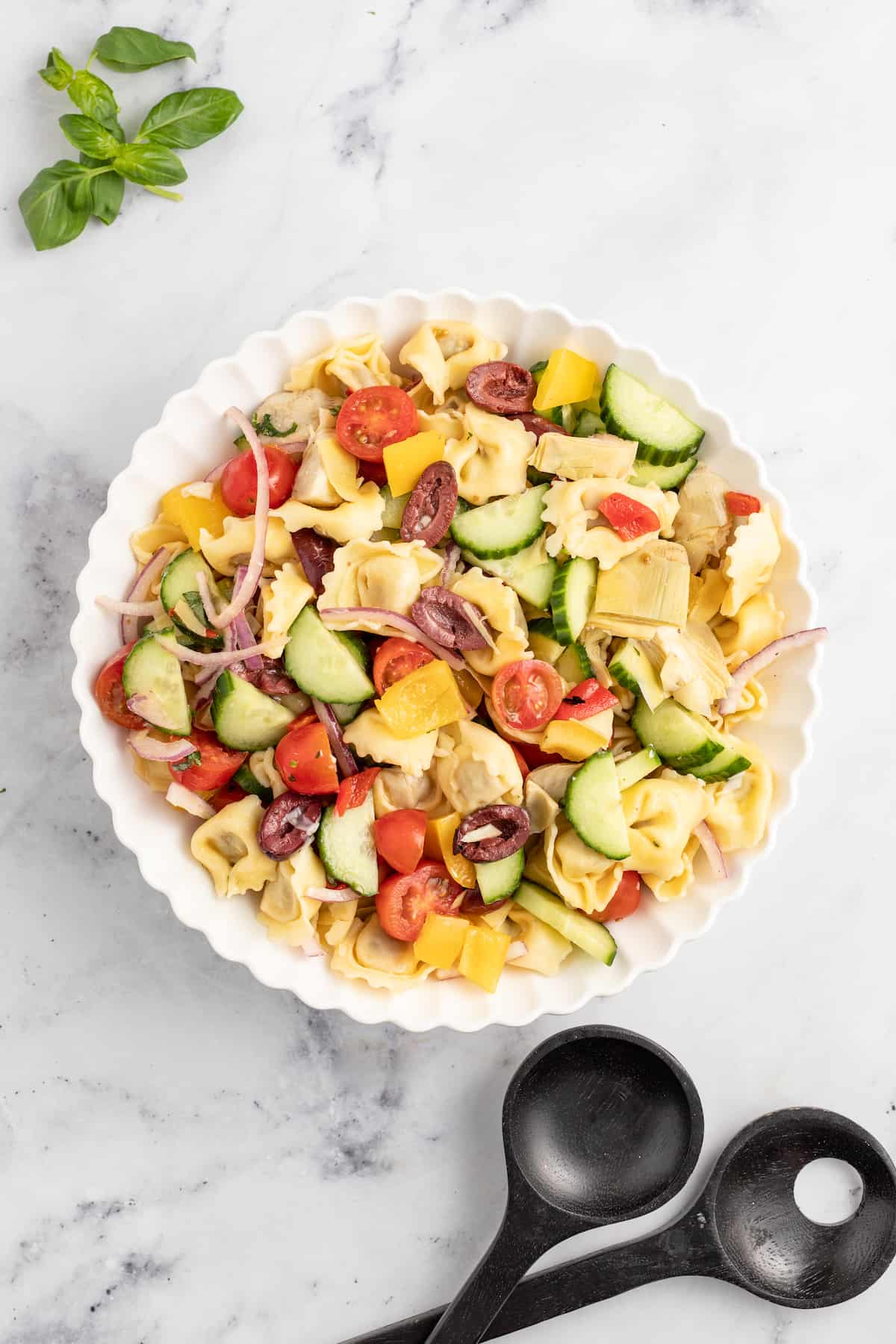 This 30-minute Greek pasta salad tossed in homemade vinaigrette will become your favorite side dish this summer with a Mediterranean flair. Bowl of Greek pasta salad.