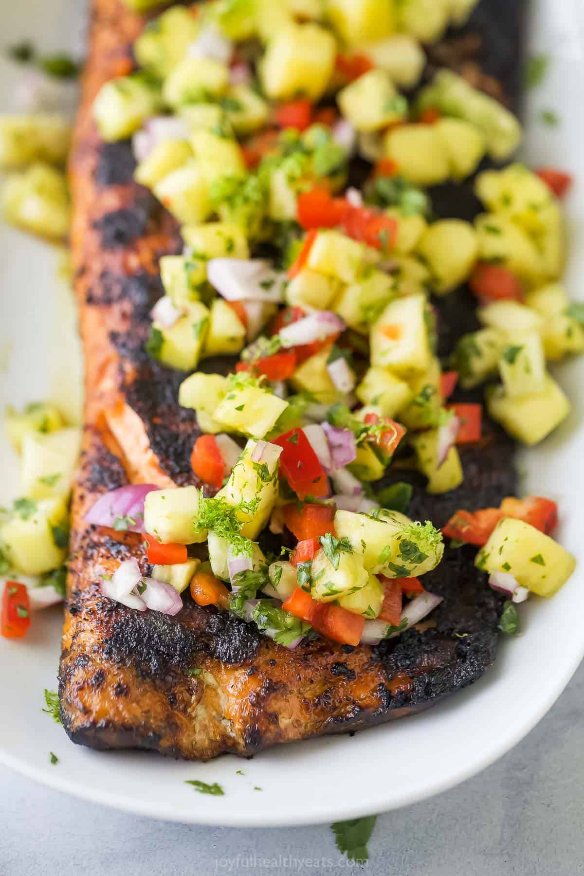 Close-up of beautifully charred salmon with pineapple salsa. 