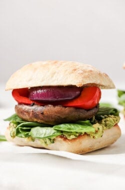 Close-up of portobello mushroom burger in a ciabatta bun.