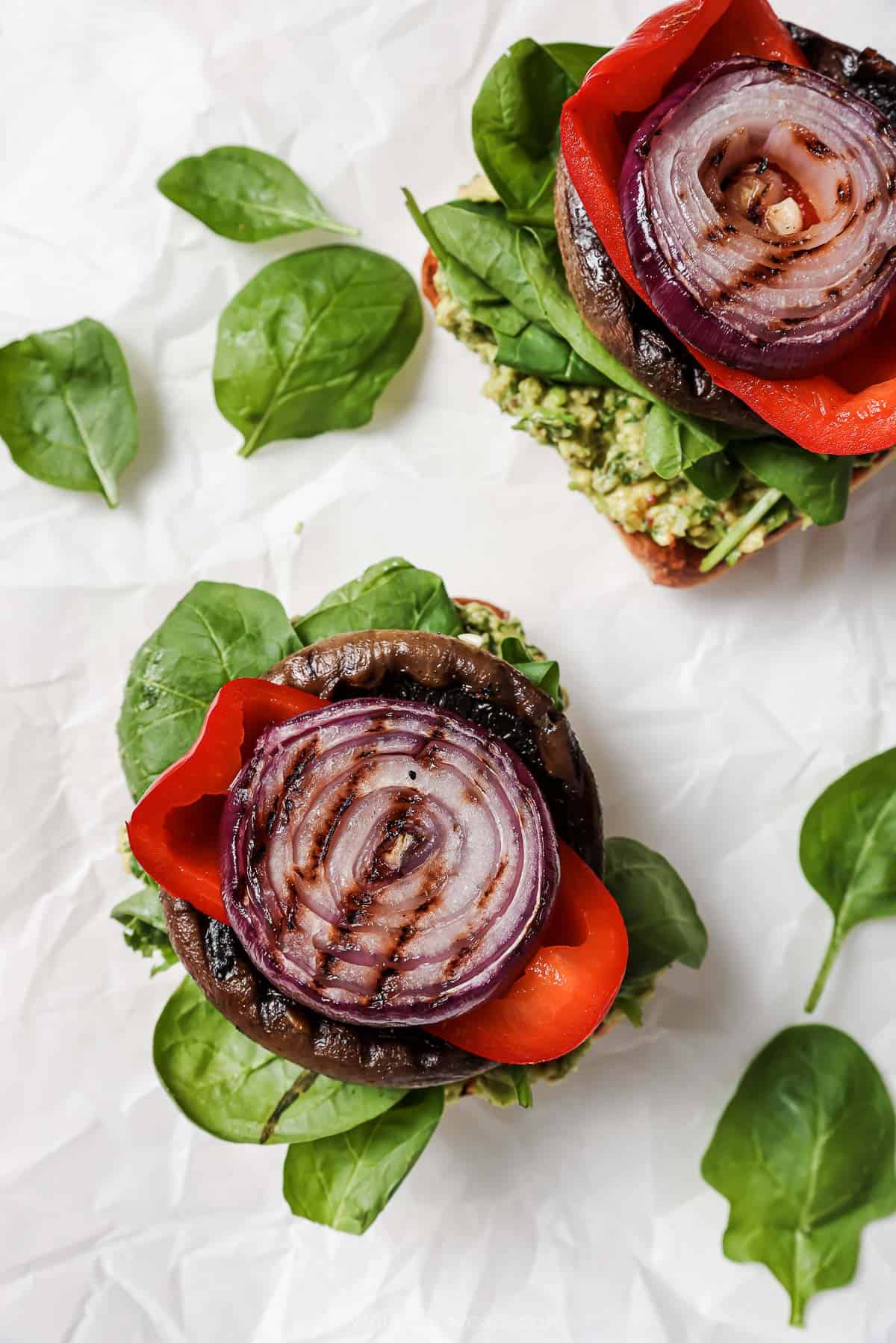 Assembling the burgers with grilled veggies.