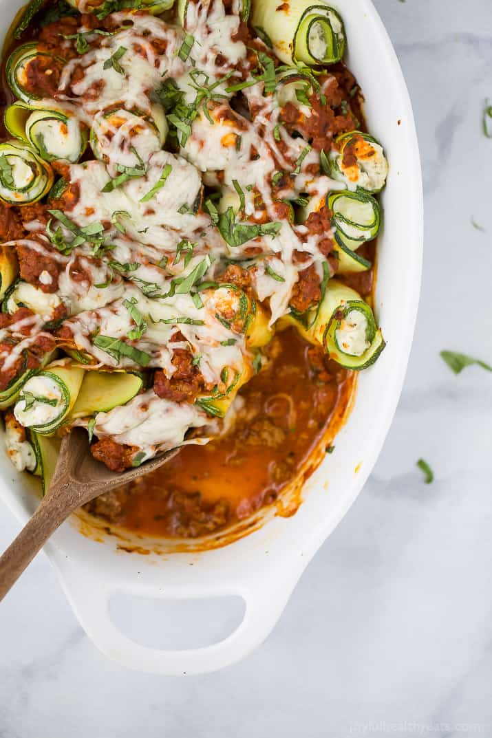 Grabbing a freshly-baked zucchini roll with melty mozzarella and lots of tomato sauce. 