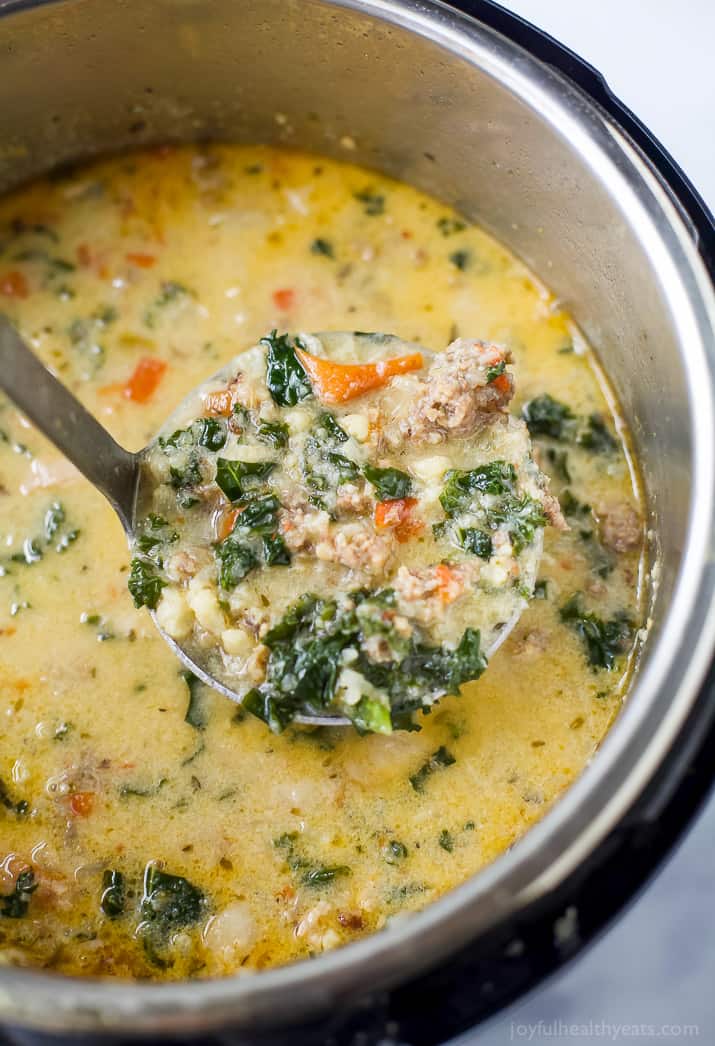 Close-up of creamy zuppa toscana in a large soup spoon straight out of the Instant Pot. 