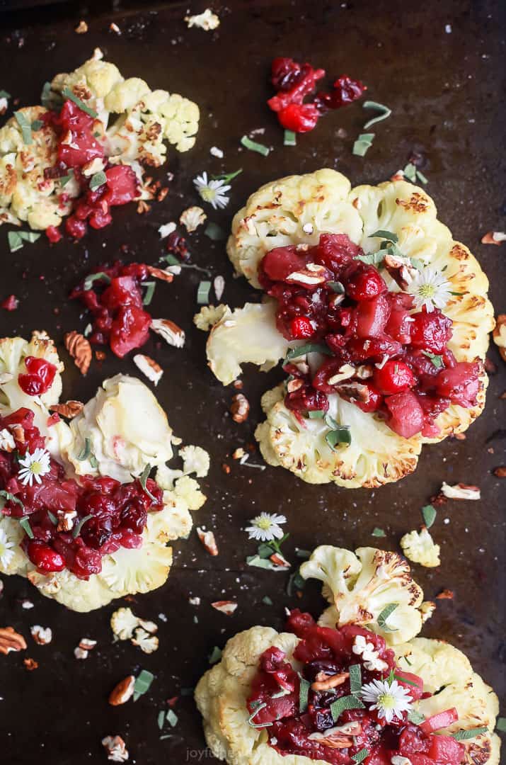 This sweet-and-savory cauliflower steak recipe with spiced maple apple-cranberry chutney is an easy but fancy main dish for the holidays. Roasted cauliflower recipe with fruity apple-cranberry chutney on top.
