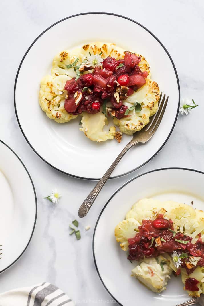 Roasted cauliflower main with homemade fruity chutney on serving plates. 