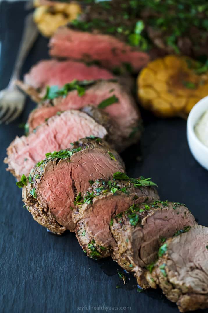 This roasted beef tenderloin recipe with a three-herb crust and creamy horseradish sauce is the perfect main for your dinner parties. Sliced beef tenderloin with an herb crust.
