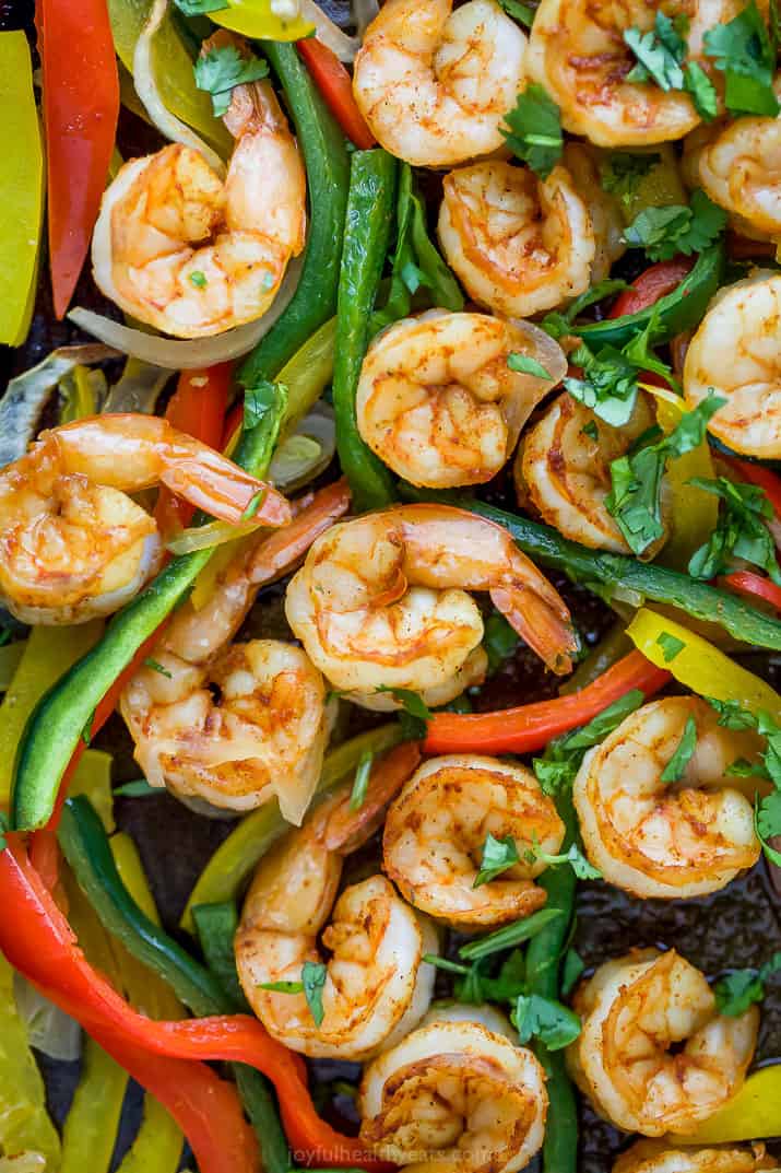 Close-up of garlicky shrimp sheet pan fajitas with peppers, poblanos, and onions. 
