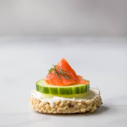 Single smoked salmon tea sandwich on countertop