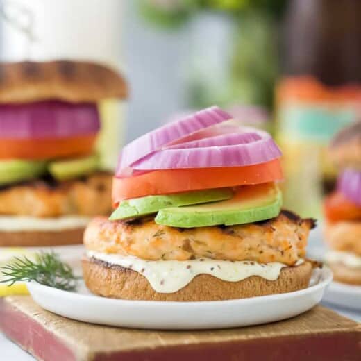 grilled salmon burger with lemon garlic aioli on a bun