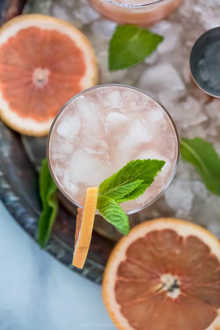 overhead of a grapefruit salty dog drink in a glass garnished with grapefruit slice