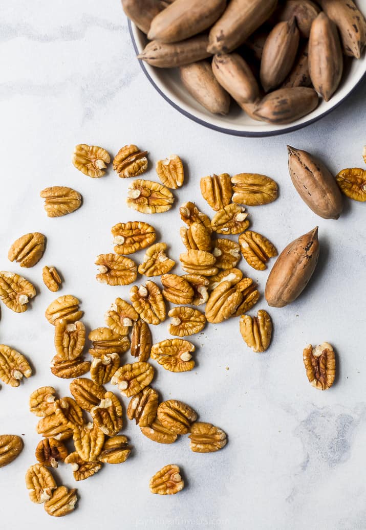 overhead photo of pecans spread out on a table