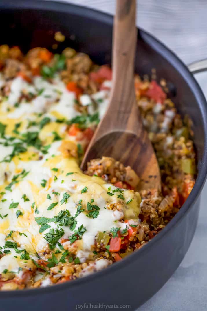 side photo of easy one pot quinoa stuffed pepper recipe topped with cheese