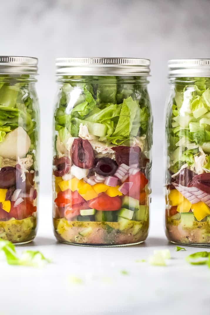 Three Greek chicken salads in mason jars