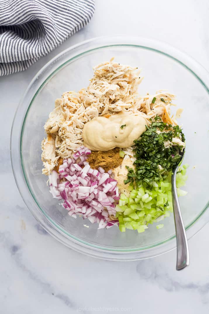 all the ingredients for avocado chicken salad in a bowl