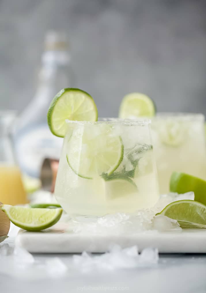 The Ultimate Skinny Margarita Recipe Two Glasses Filled with Homemade Margaritas and Pieces of Fresh Lime