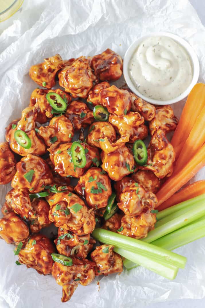 air fryer honey bbq cauliflower wings in a basket with veggies