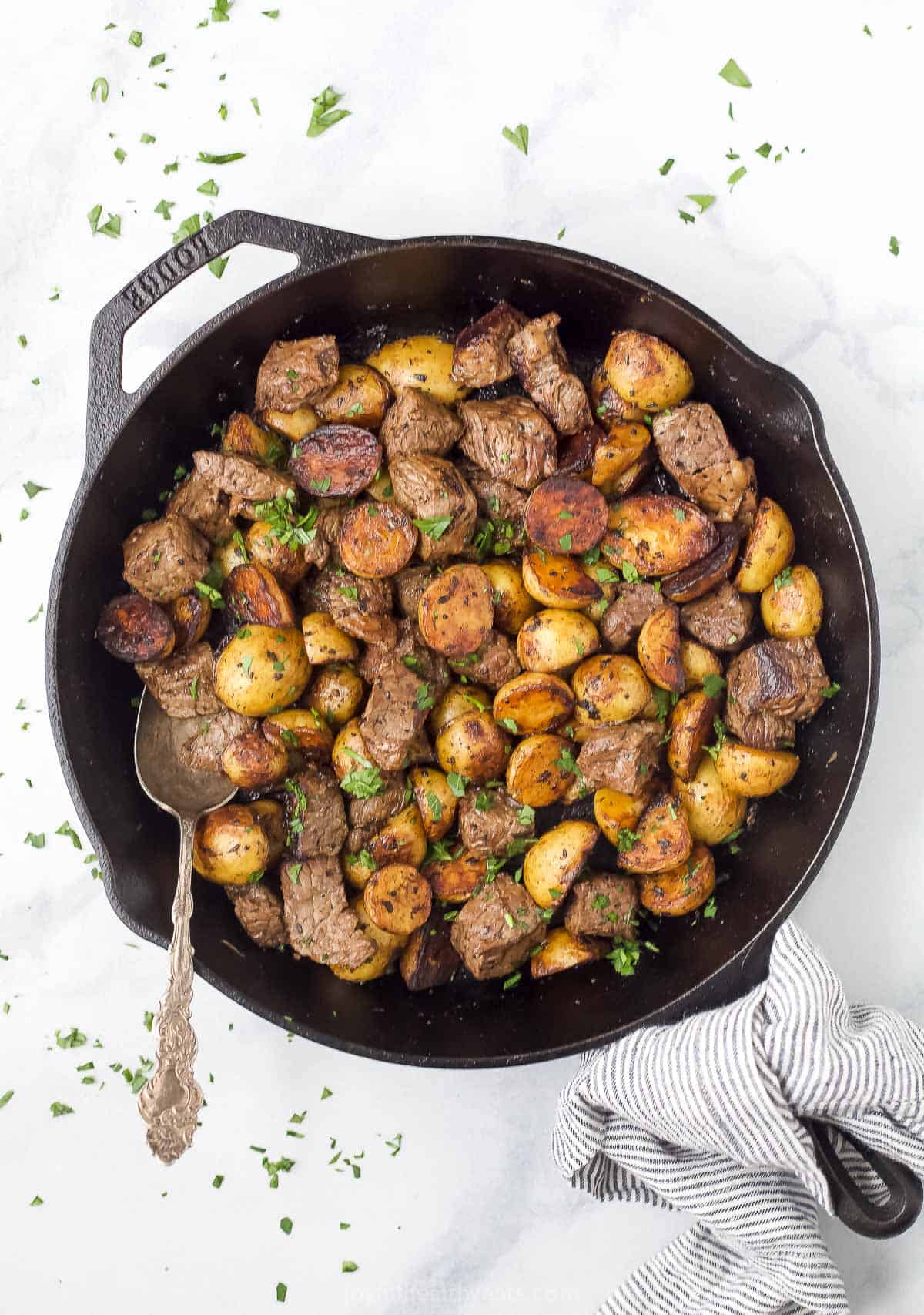 Overhead view of garlic butter steak and potato skillet