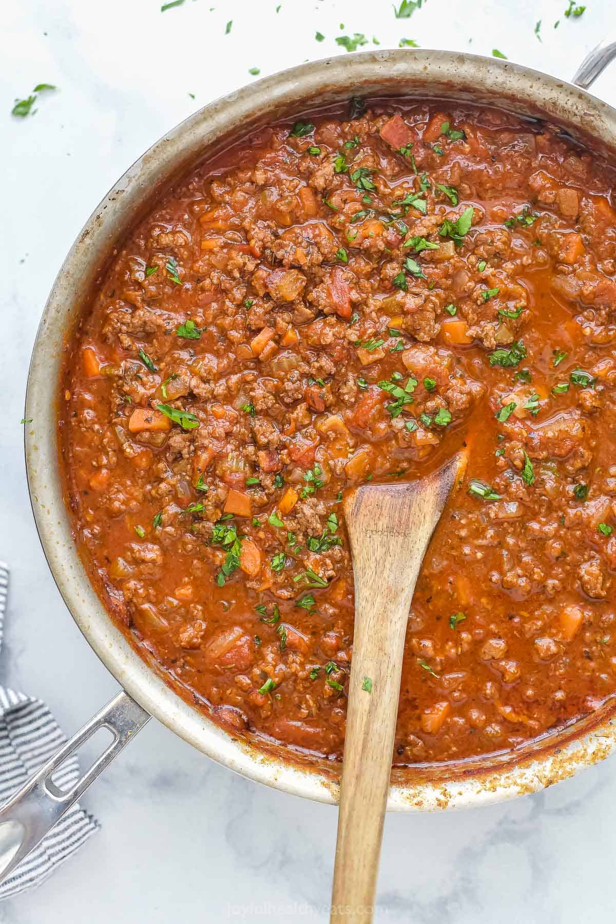 This Homemade Ragu Sauce is a quick version of an Italian staple. It's hearty and rich! The beef and tomato flavors develop in about one hour. Ragu sauce simmering in pan with beef, vegetables, and tomato sauce