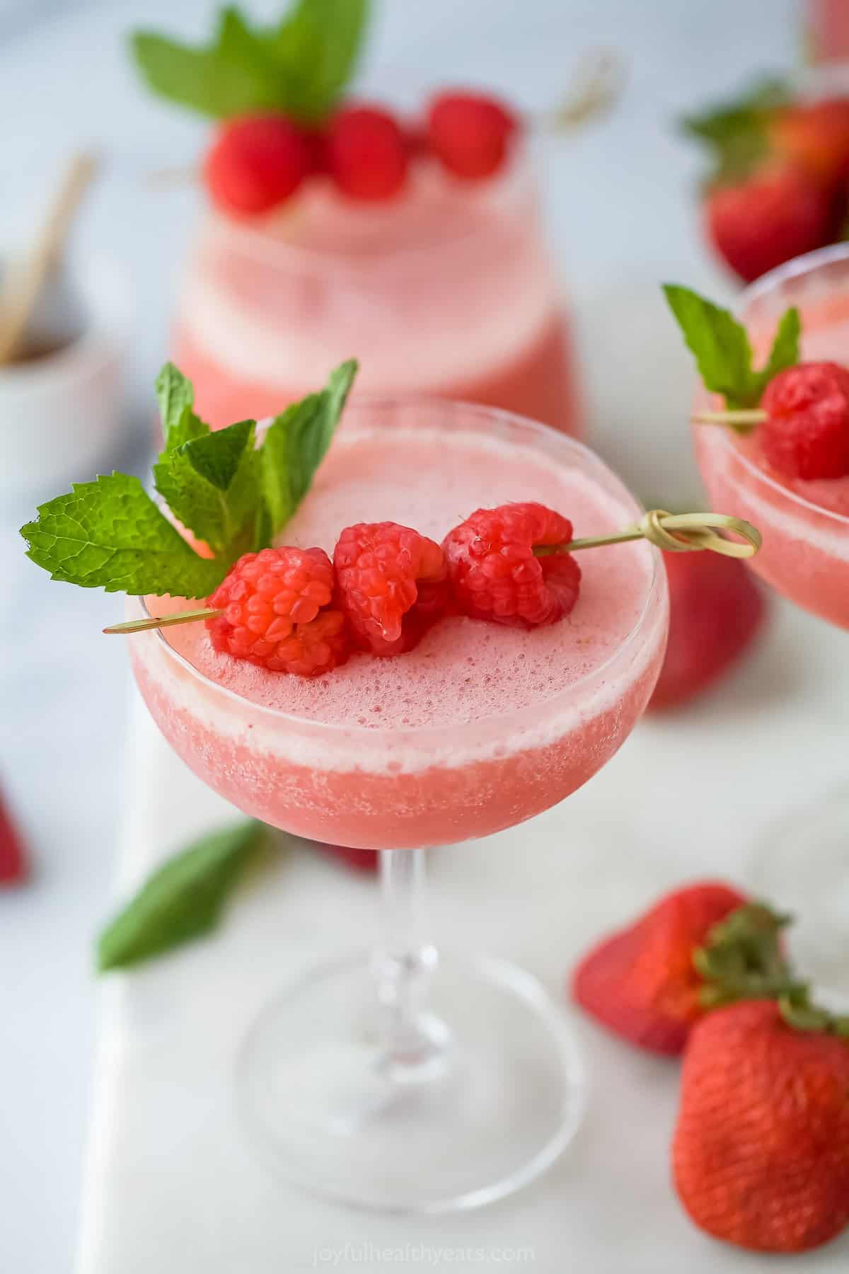 This Easy No Prep Frosé is fruity, a little tart, and refreshing. If you love rosé, you'll love this frozen version. It's so easy to make! frozen wine with raspberry and mint garnish