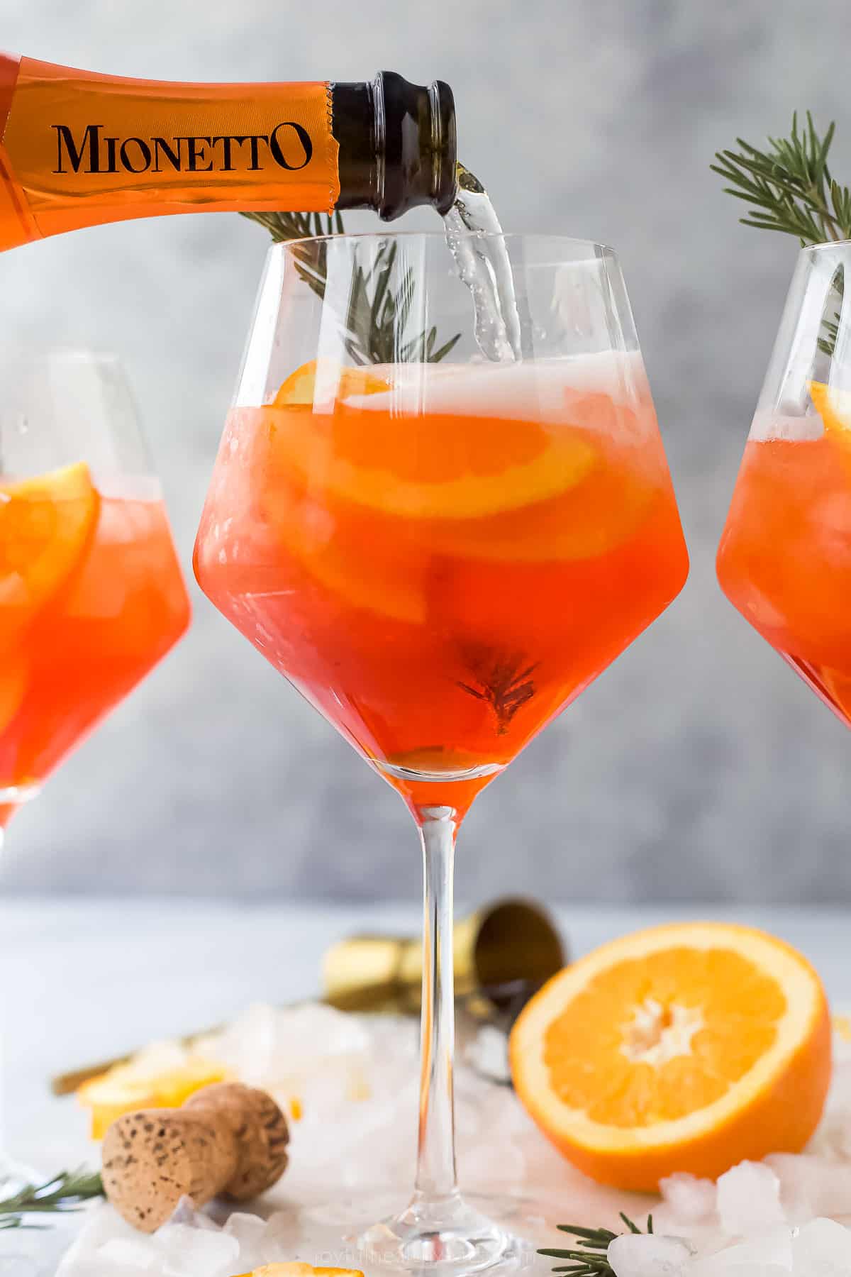 This light and refreshing Holiday Aperol Spritz is the perfect Christmas cocktail. It has tangy cranberry juice, Aperol, and prosecco. a glass of Holiday Aperol Spritz with rosemary garnish