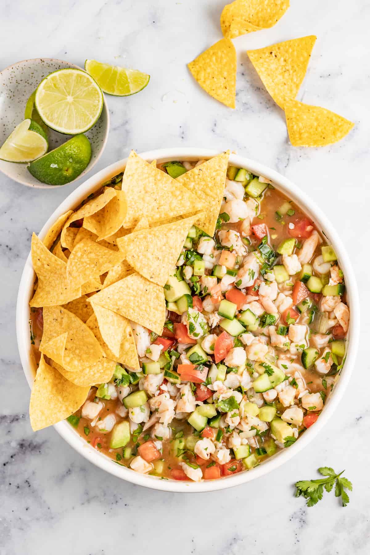 This crunchy and tangy ceviche de camaron is a refreshing summer recipe loaded with veggies, avocado, and a bit of chile. You'll love it! Bowl of ceviche de camaron with tortilla chips.