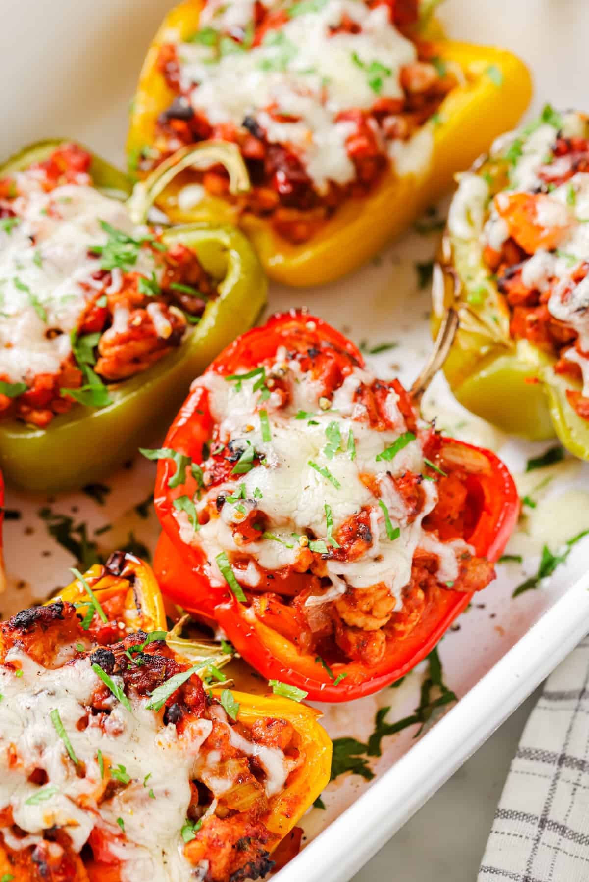Close-up of ground turkey stuffed peppers in the baking dish