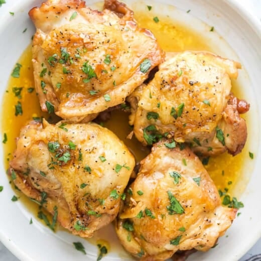 Four chicken thighs with honey garlic sauce.