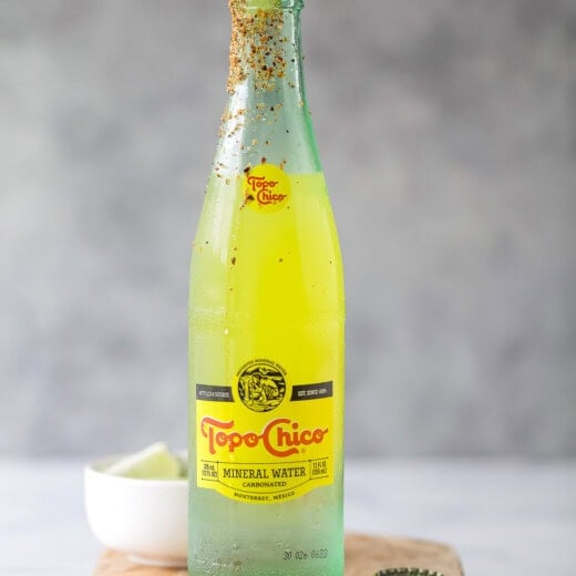 Ranch water recipe with a lime wedge and Tajin rim.