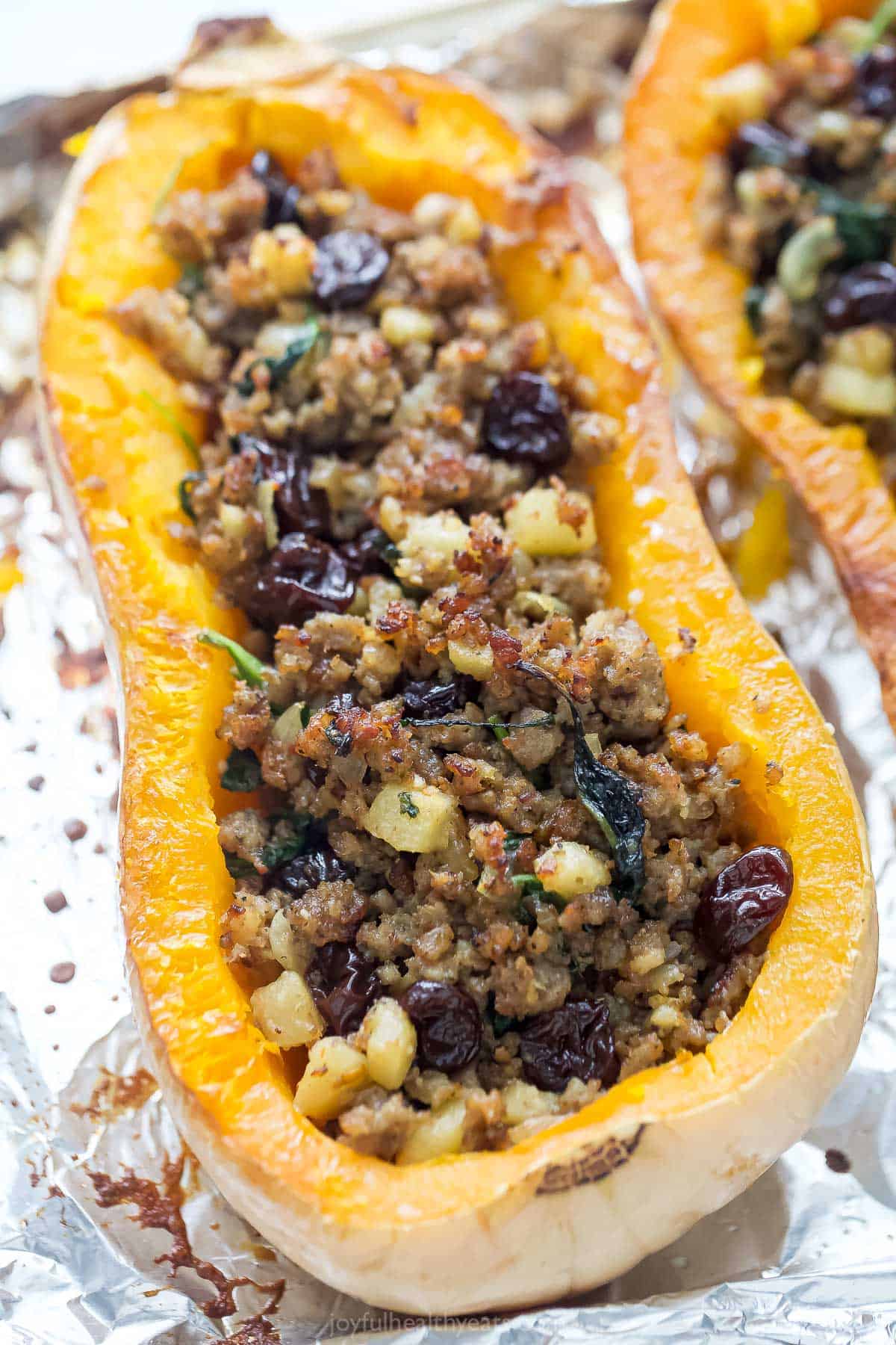 A whole stuffed butternut squash with juicy, sautéed sausage apple-spinach filling.