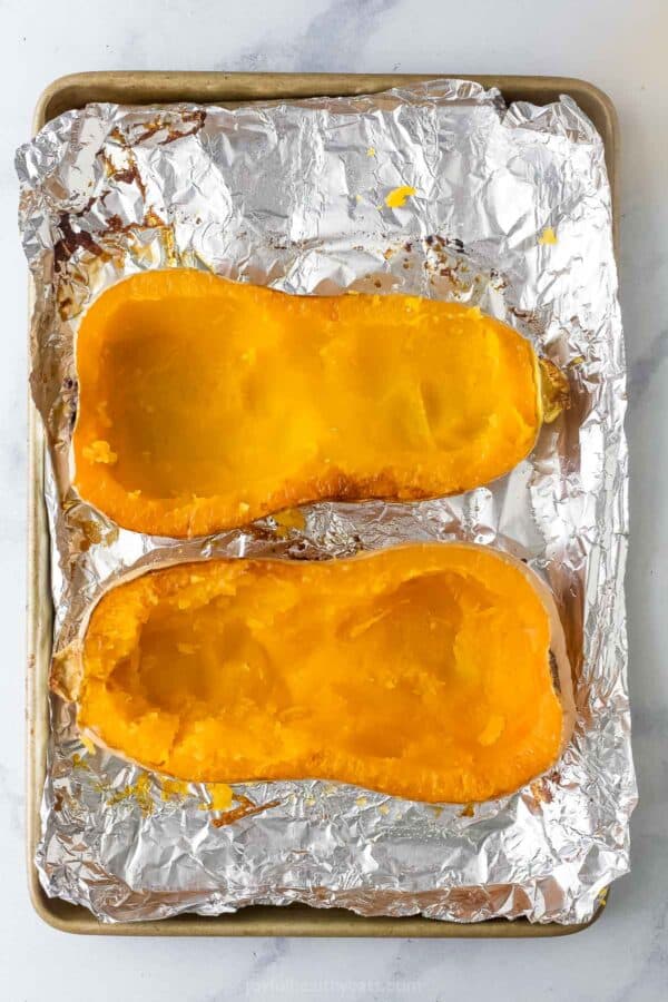 Roasted butternut squashes on the prepared baking sheet.