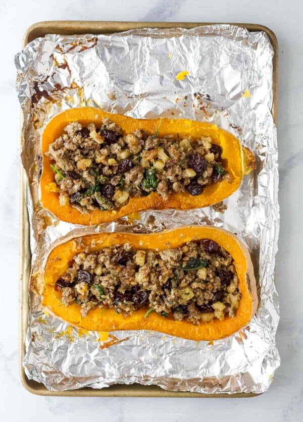Broiled stuffed butternut squash with apple-sausage filling.