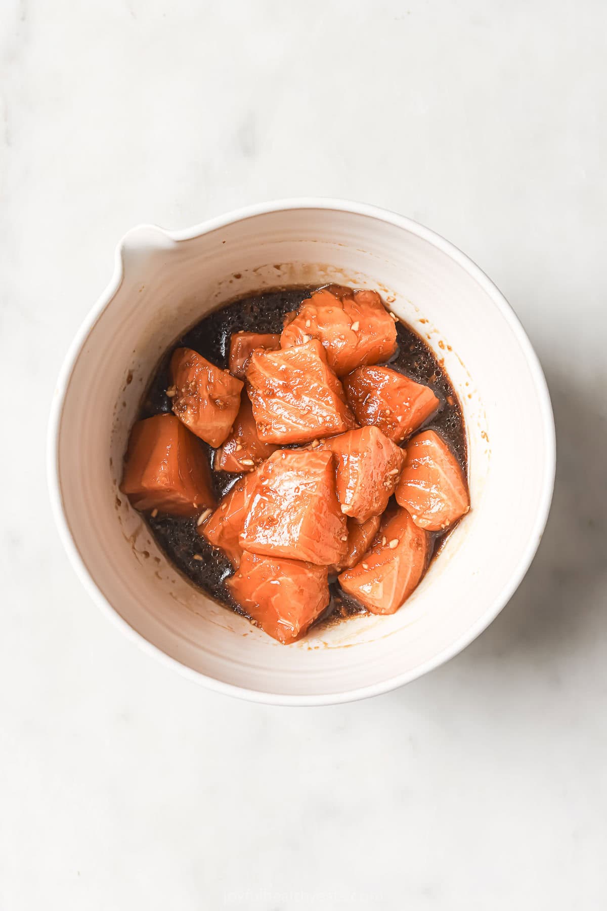 Salmon in bowl of marinade