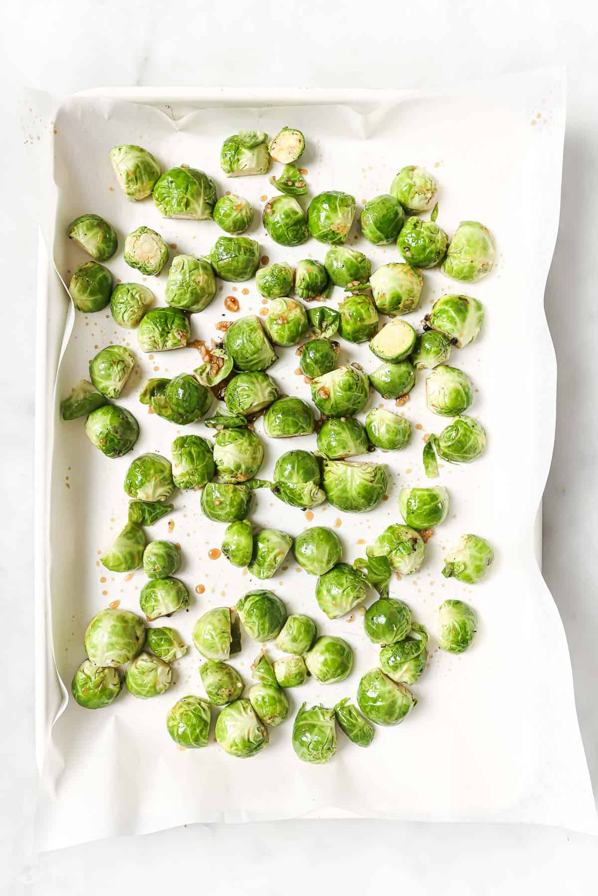 Overhead view of Brussels sprouts on parchment-lined sheet pan