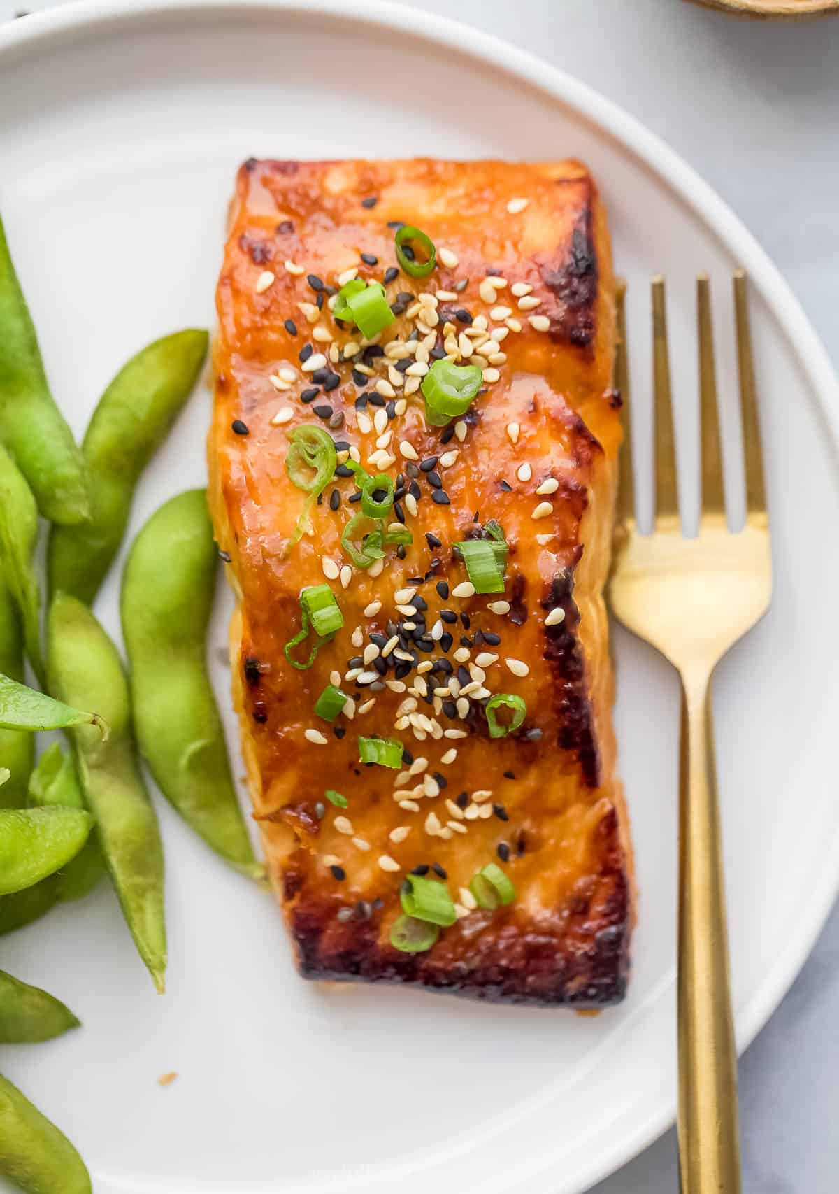 Miso salmon is an easy weeknight recipe that tastes like it came out of a restaurant! You’ll love the sweet, savory and umami flavors. Miso salmon fillet on plate with fork