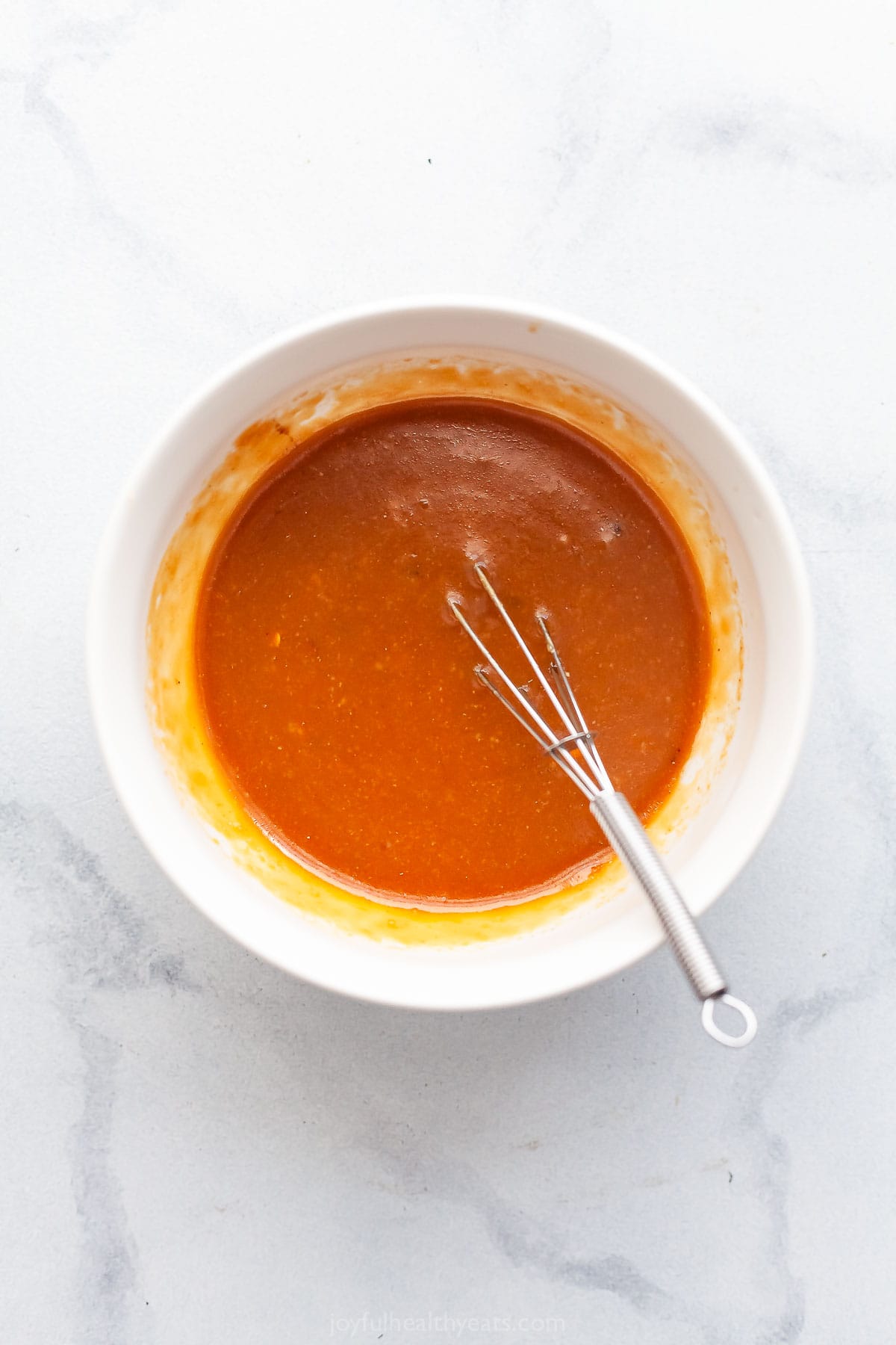 Miso glaze in bowl with whisk