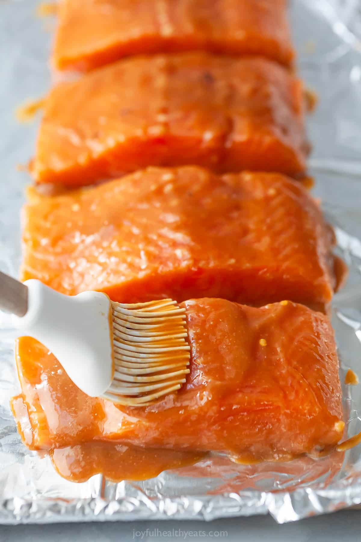 Brushing glaze onto salmon