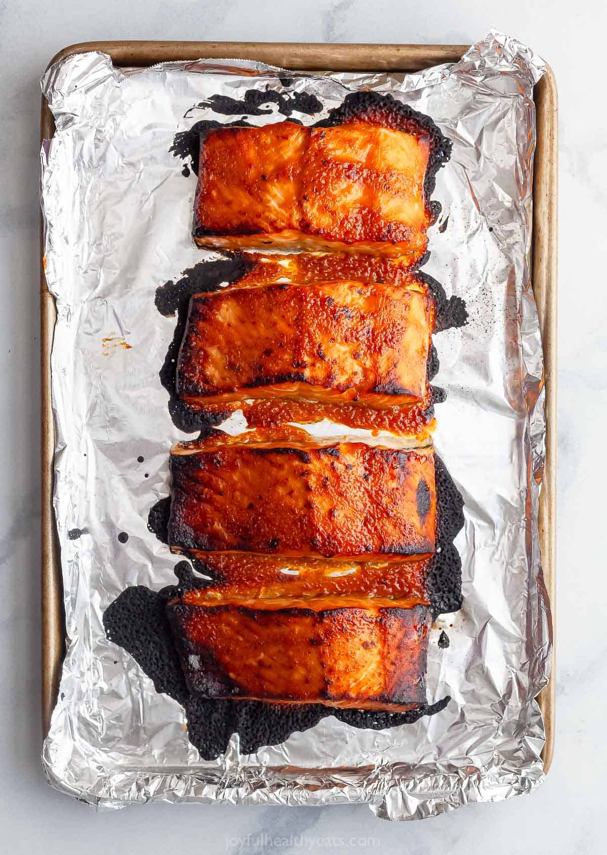 Overhead view of miso salmon on foil-lined baking sheet