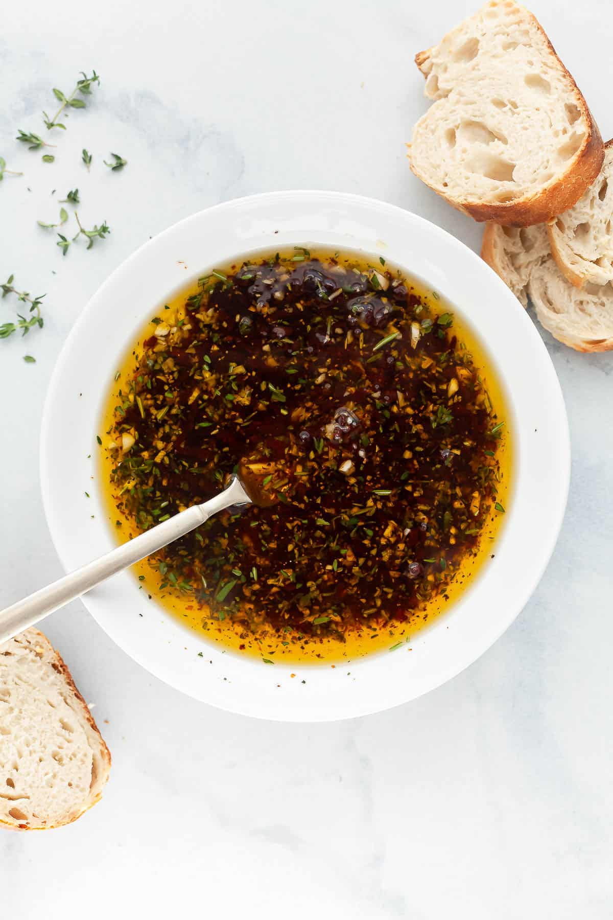 Bowl of bread dipping oil with spoon