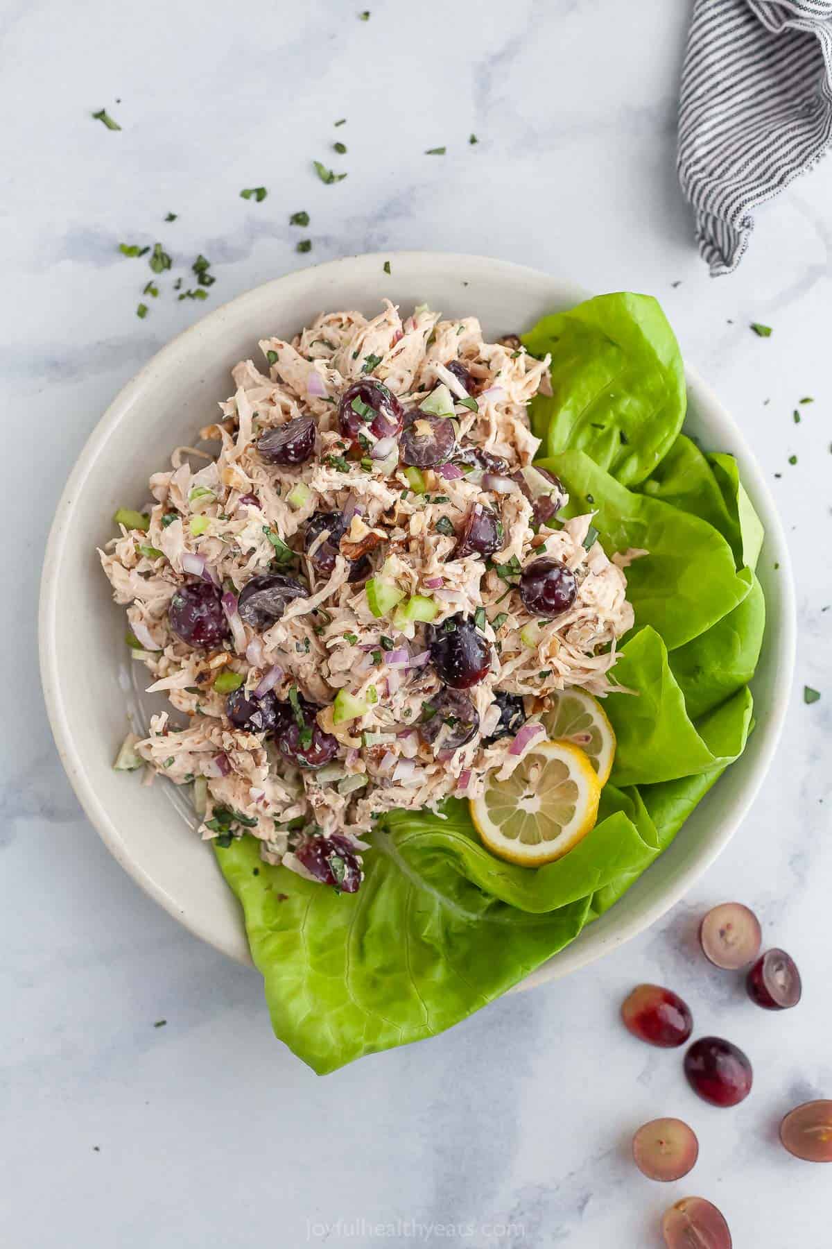 Overhead view of Waldorf chicken salad with lettuce leaves