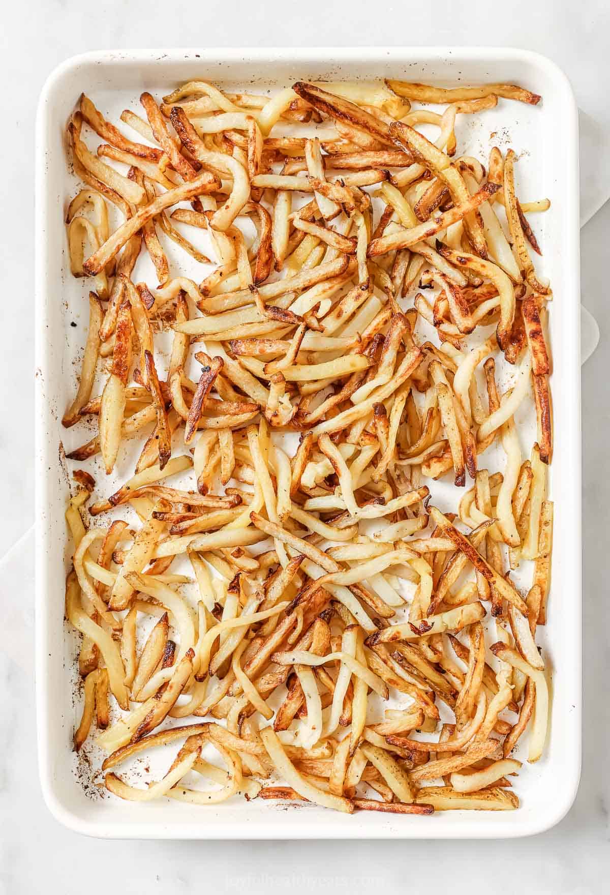 Truffle fries on pan before garnishing