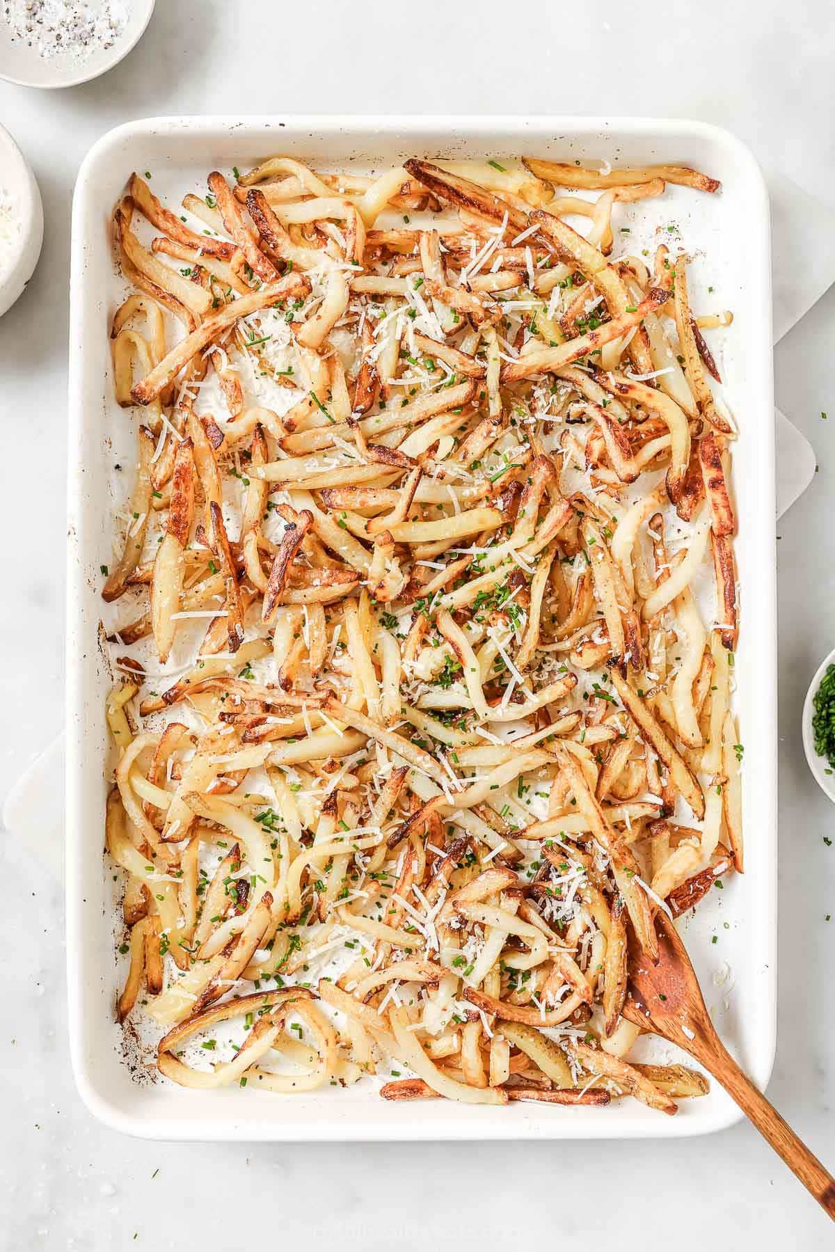 Overhead view of Parmesan truffle fries on pan