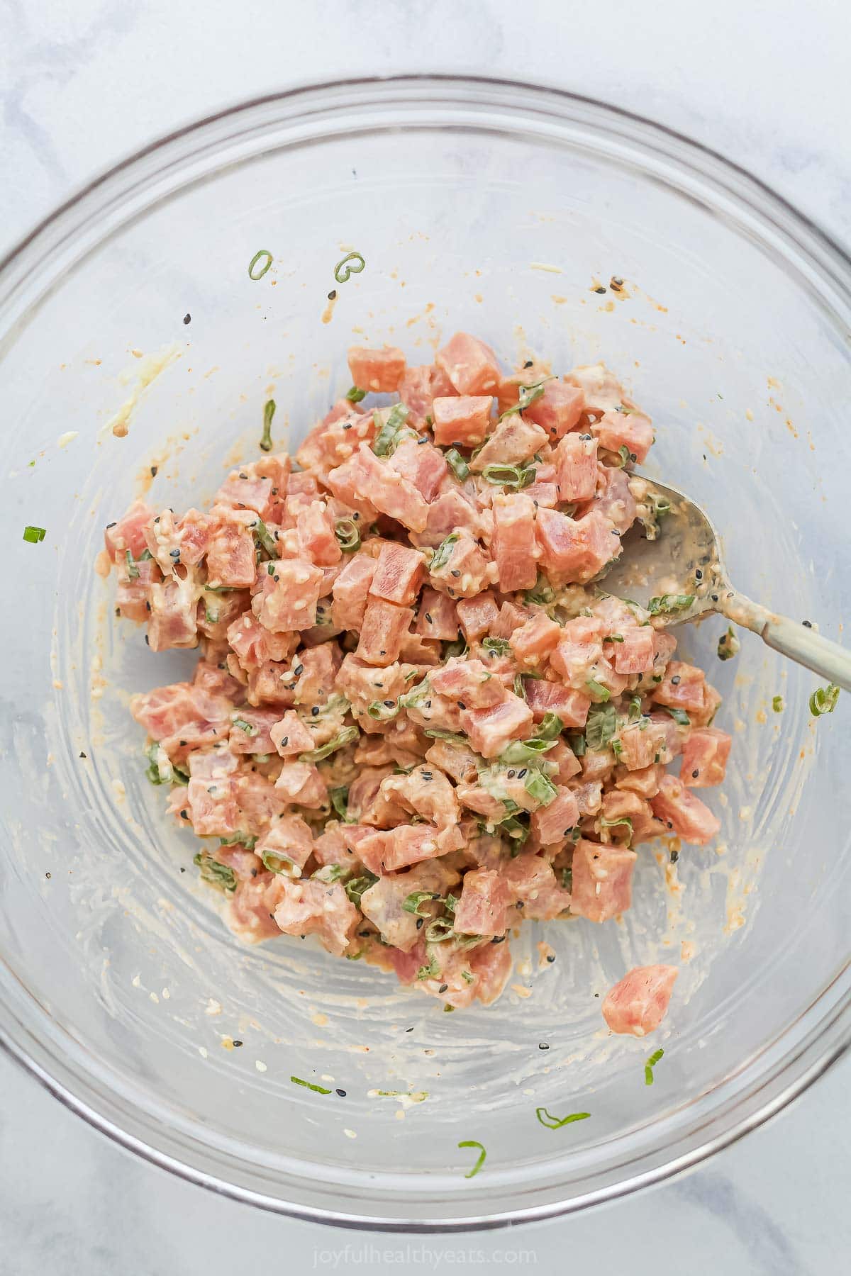 Overhead view of spicy tuna in glass bowl