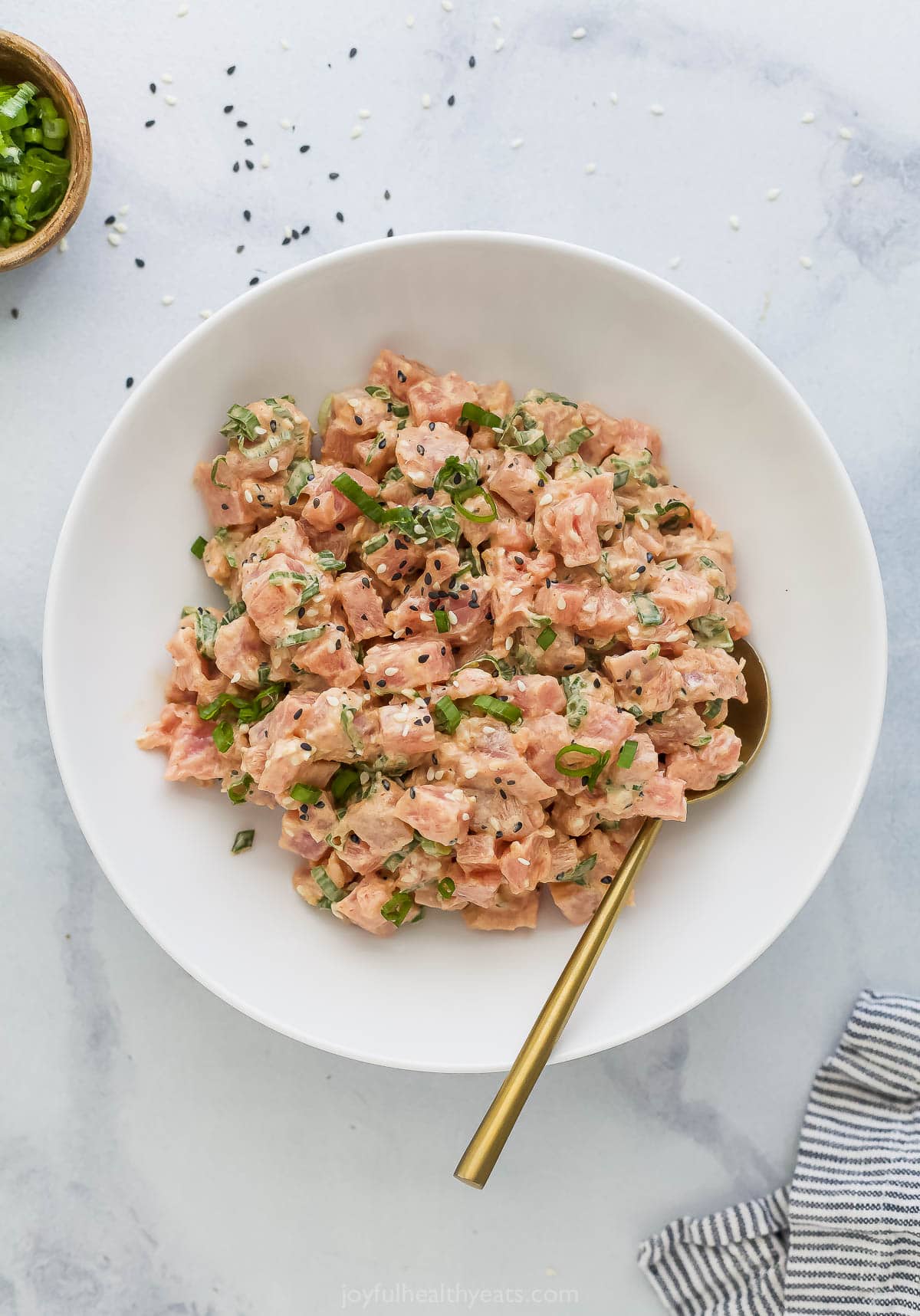 Bowl of spicy tuna with gold spoon